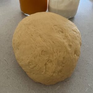 Pumpkin bagel dough has been kneaded into a smooth, pliable dough.