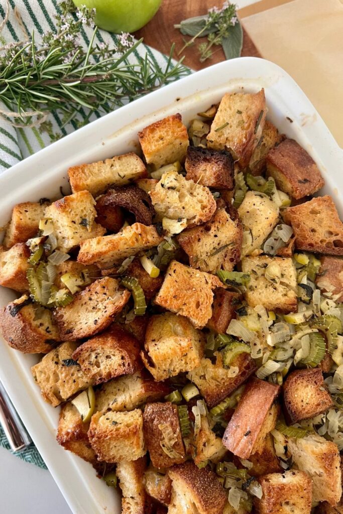 Thanksgiving sourdough stuffing served in a rectangular baking dish.