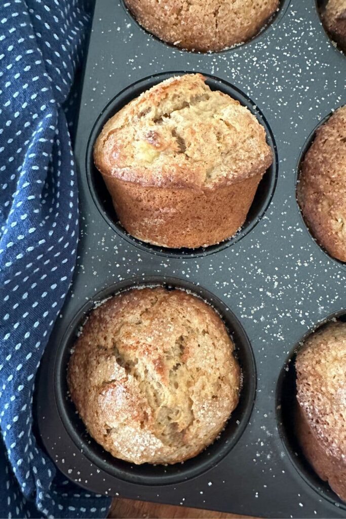 Sourdough banana muffins that have been baked and are sitting in a muffin pan.
