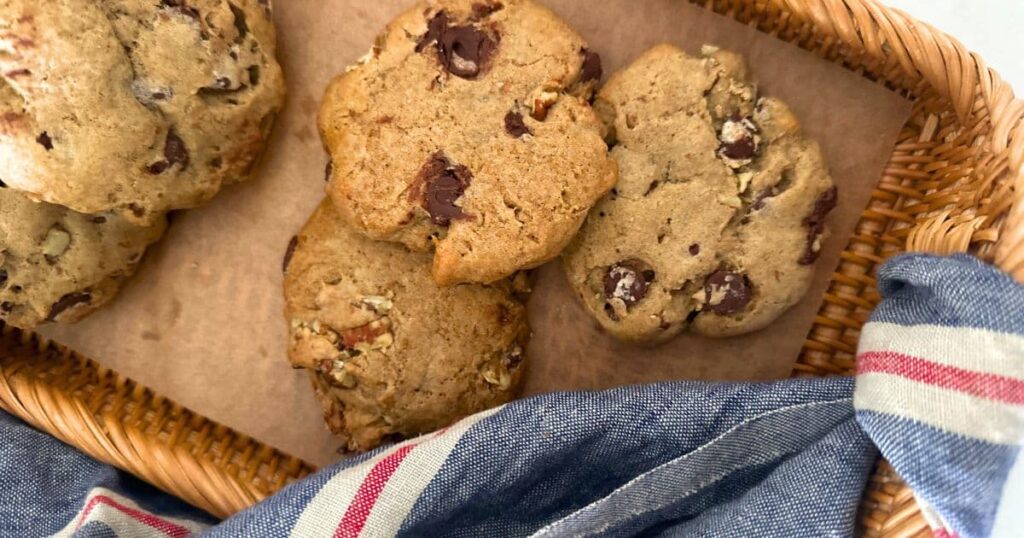 Spiced pecan sourdough cookies displayed on a rattan tray.