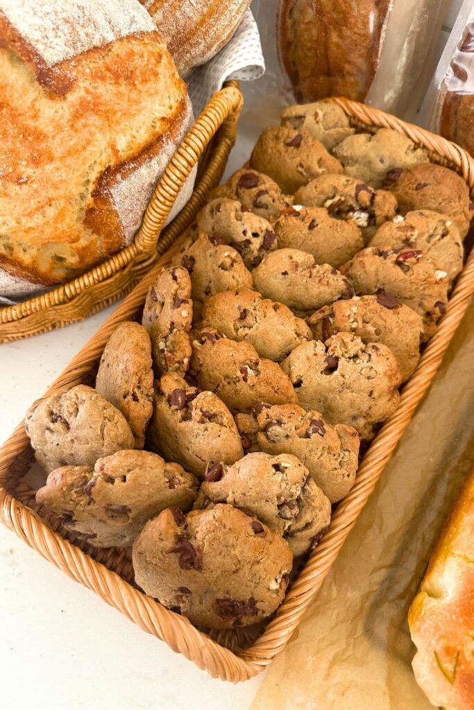 Spiced pecan sourdough cookies displayed on a rattan tray.