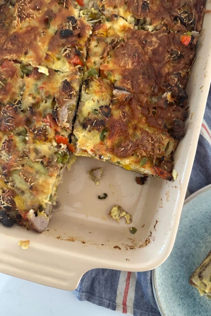 A casserole dish filled with sourdough breakfast casserole using leftover sourdough bread.