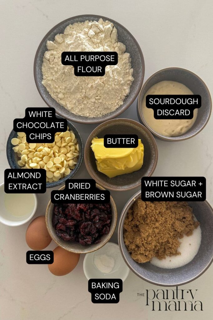 A flat lay of ingredients necessary to make sourdough white chocolate cranberry cookies.