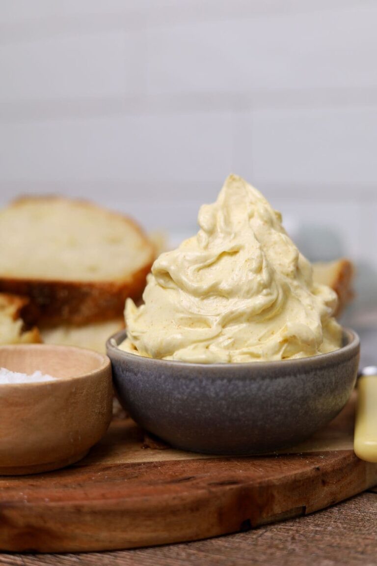 A small grey dish of whipped brown butter stacked high up.