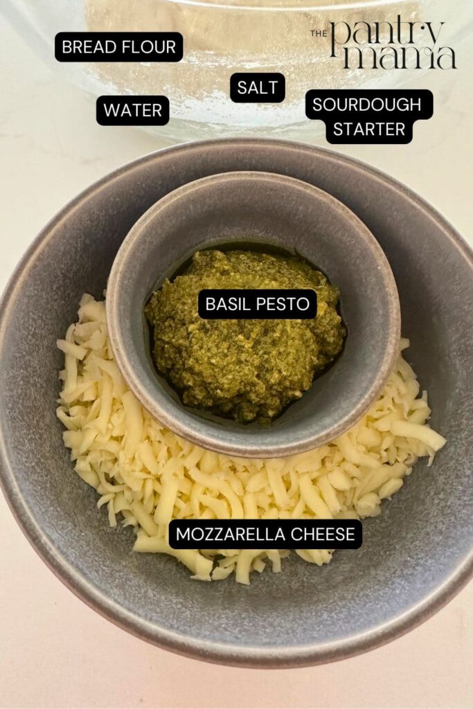 Flat lay of ingredients necessary to make sourdough bread with pesto mozzarella.