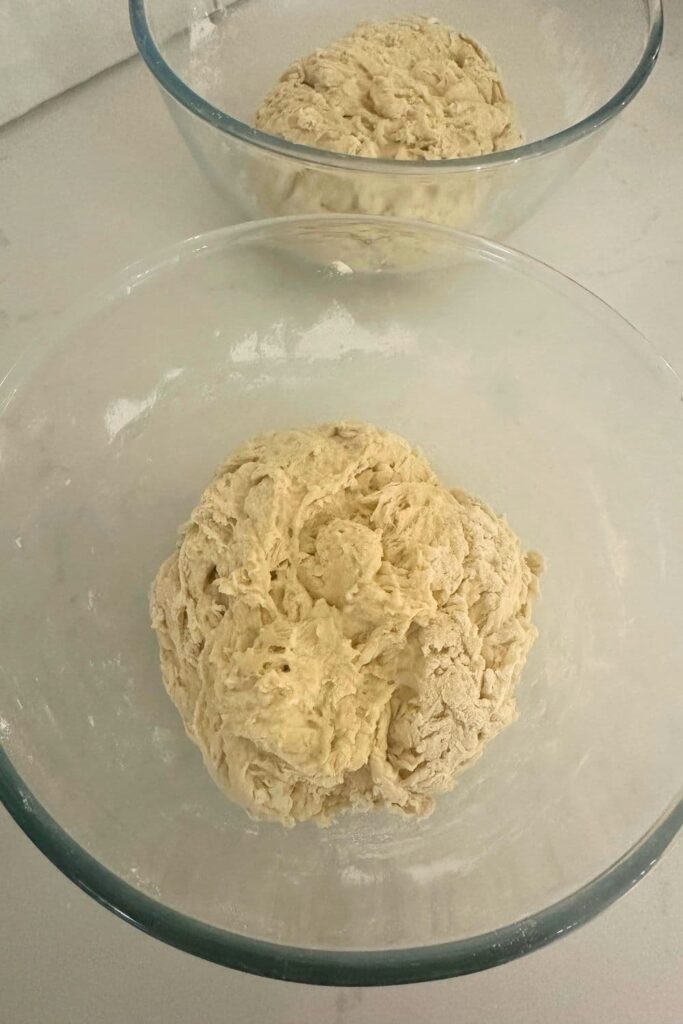 2 glass bowls containing a dry sourdough dough mixture.