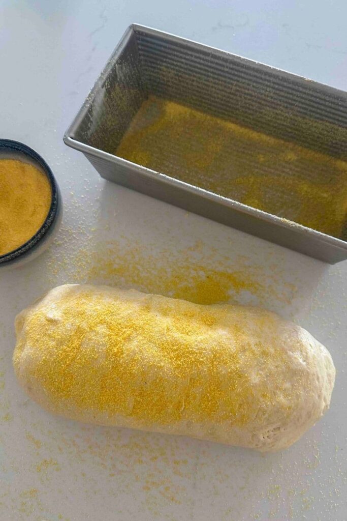 Sourdough English muffin loaf dough rolled and ready to put in loaf pan.