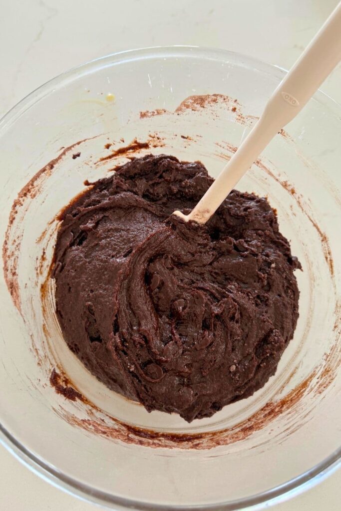 Sourdough cosmic brownies batter mixed together in glass bowl.
