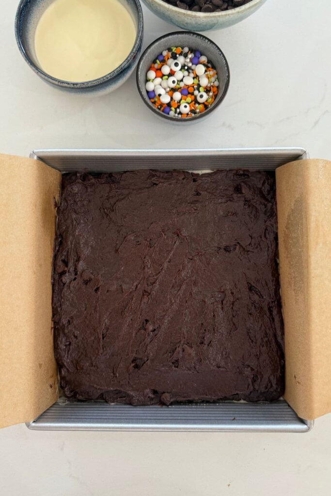Sourdough Halloween frosted brownie batter in baking pan.
