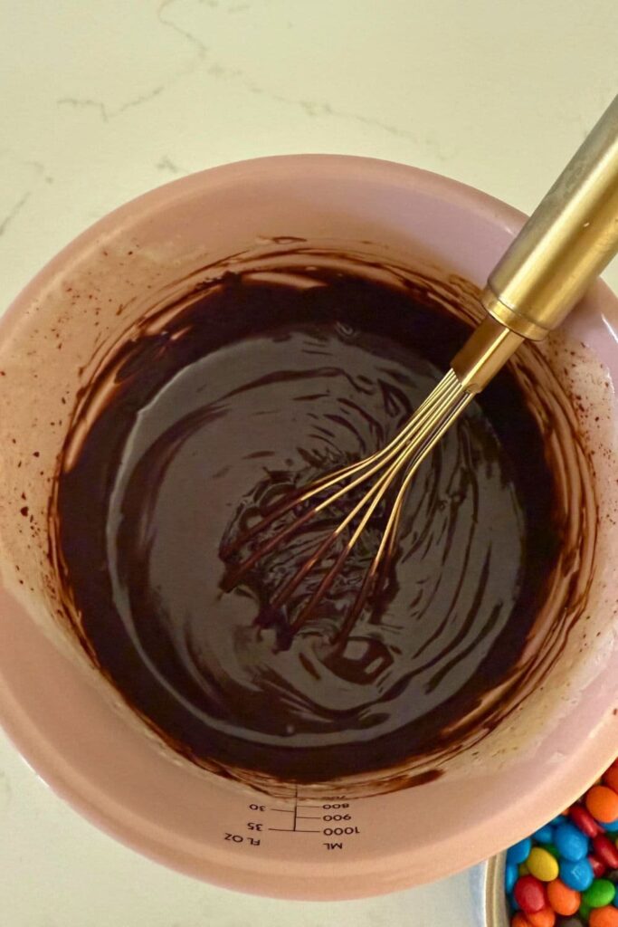 Sourdough Halloween frosted brownies ganache topping mixed in bowl.