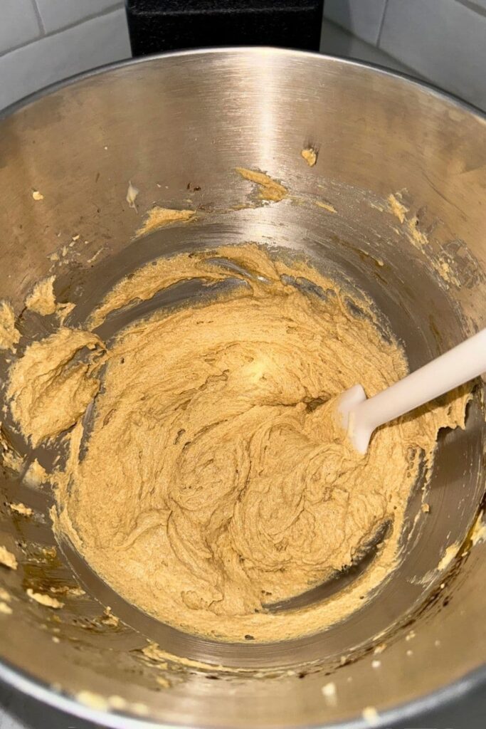 Creaming together butter and sugar in mixing bowl for sourdough ginger molasses cookies.