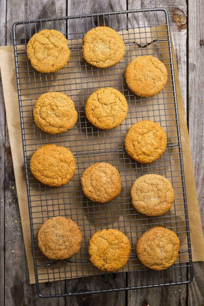 sourdough ginger molasses cookies cooling on wire rack.