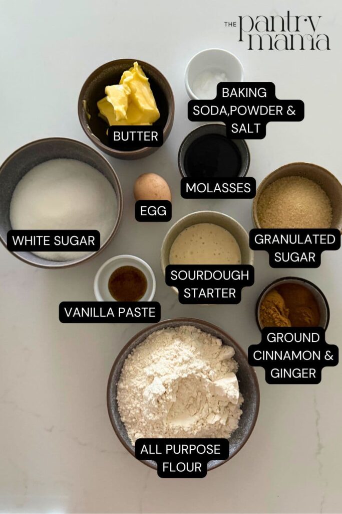 sourdough ginger molasses cookies labeled ingredients on counter.