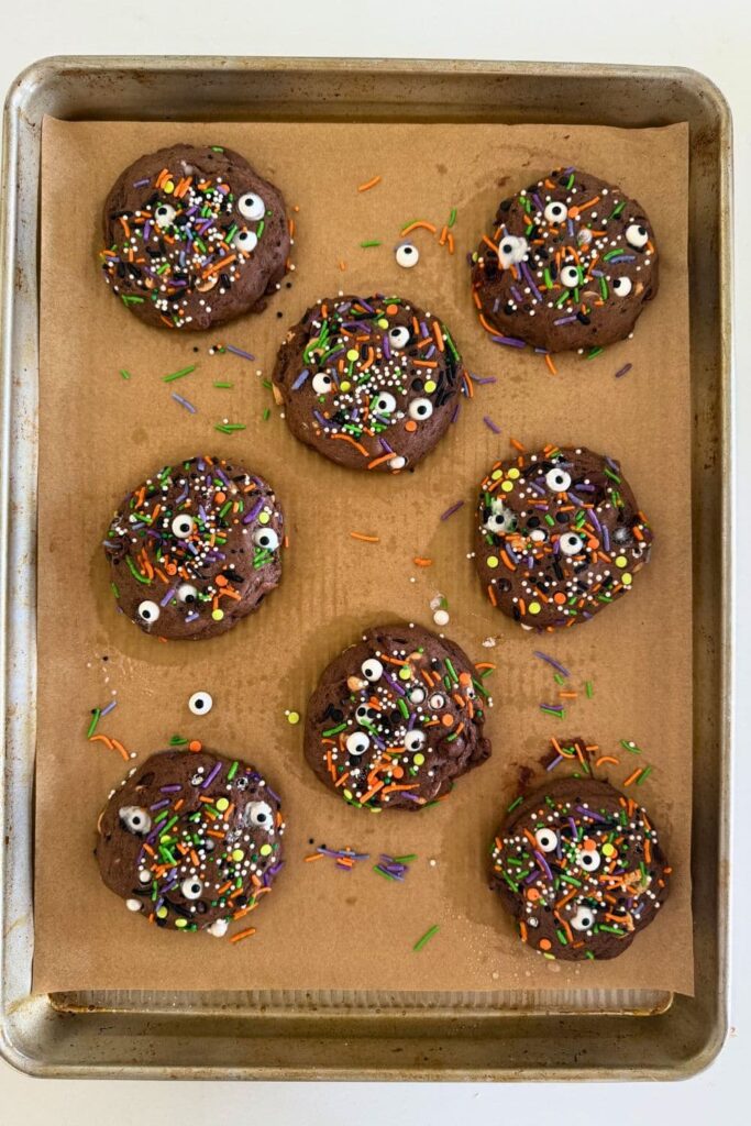 Baked sourdough Halloween cookies on parchment lined baking sheet.