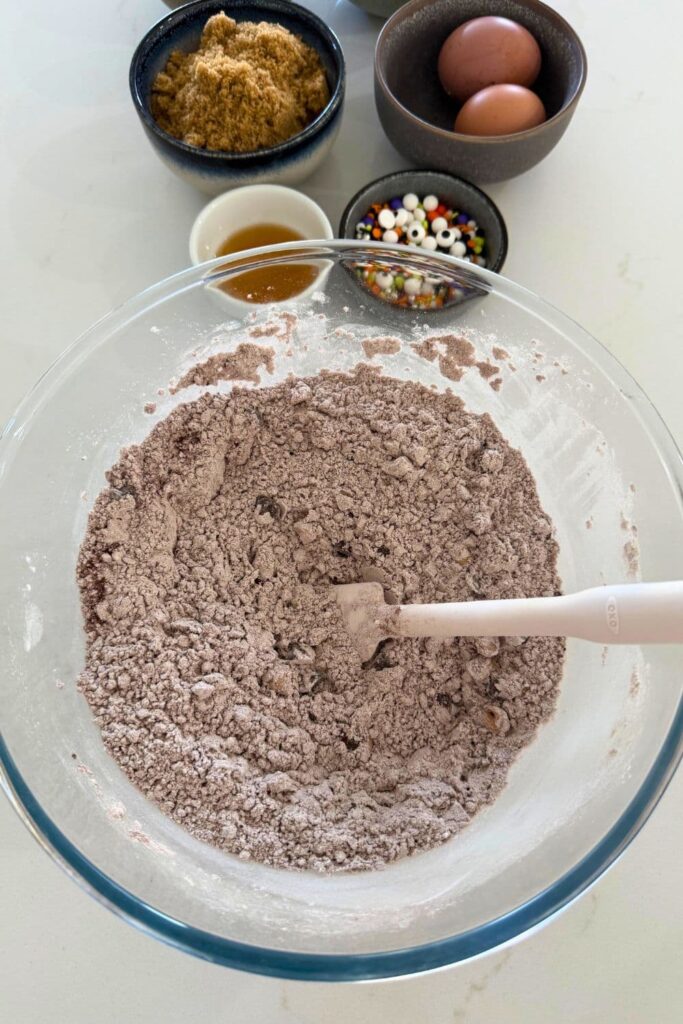 Dry ingredients for sourdough Halloween cookies in a glass bowl.