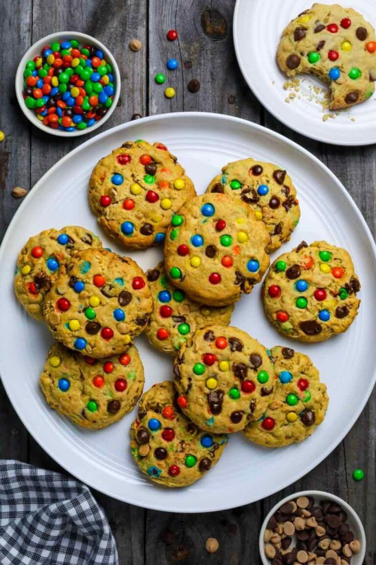 Plate with sourdough monster cookies sitting on wooden table.