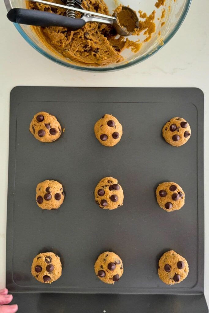 Sourdough pumpkin chocolate chip cookie dough balls on baking sheet.