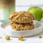 Two sourdough apple cinnamon oatmeal cookies stacked on a plate for serving.