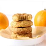 A stack of sourdough pumpkin snickerdoodles on a white plate.