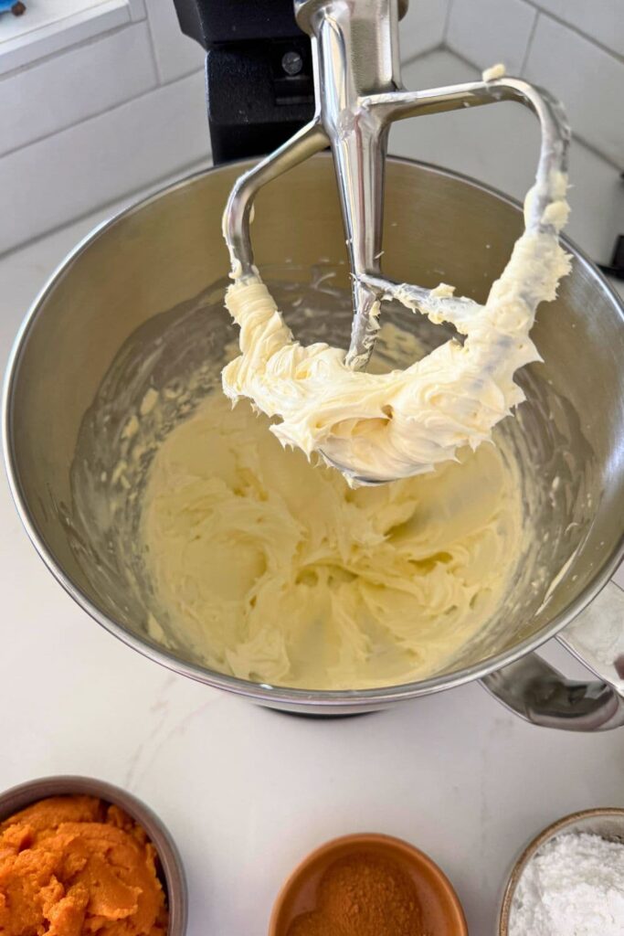 Cream cheese and heavy cream whipped together in a stainless steel stand mixer bowl. You can see the paddle attachment in the photo.