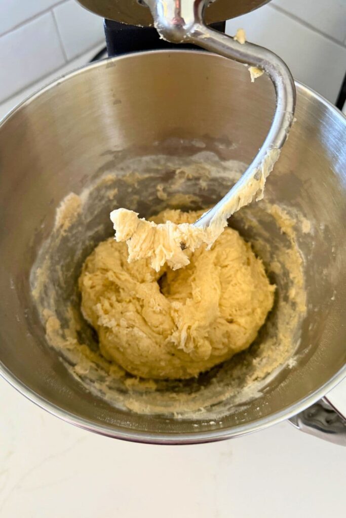 Mixing dough in a stand mixer to make a sourdough maple pecan twist loaf.