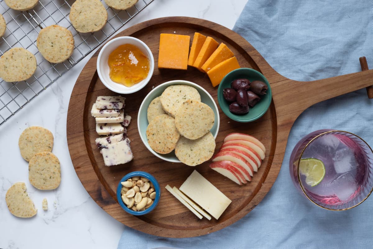 A cheese and appetizer board featuring sourdough discard rosemary and parmesan shortbread for snacking.