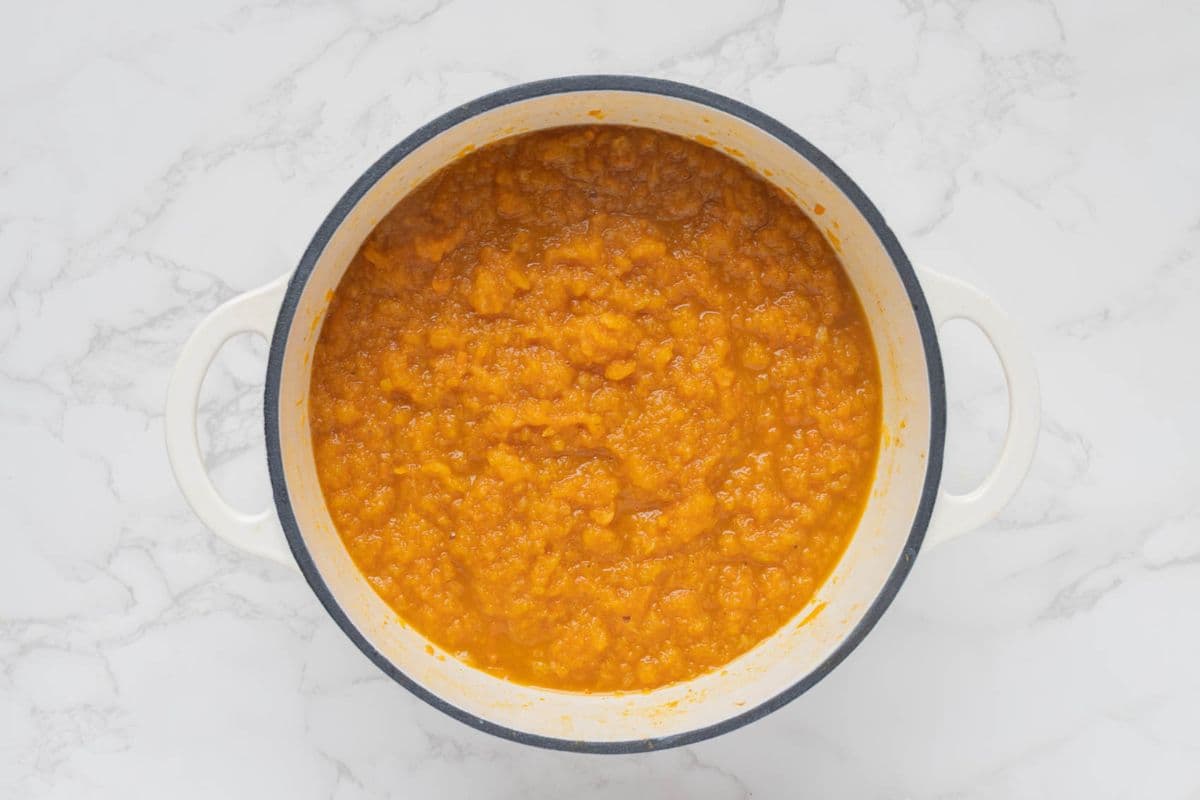Blended ingredients for carrot cake jam in a pot just before cooking again.
